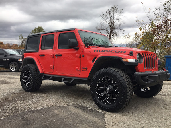 2018 Jeep Wrangler JL with 2.5 Rough Country lift kit and 20x9 Fuel Offroad Assault wheels with 35 inch Nitto Ridge Grappler tires and Rough Country nerf bars and Rough Country LED light bar and pod lights 