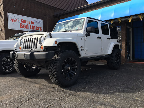 2013 Jeep Wrangler with a 4 inch Zone Offroad lift kit and 20x10 KMC XD Monster wheels and 35 inch Mastercraft MXT tires 