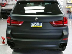 2016 BMW X5 with 3M vinyl wrap and powder coat OEM wheels gloss black.