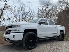 Chevy 1500 leveled up with 22x10 Hostile Sprockets and 33x12.50x22 Nitto Terra Grapplers