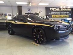 2015 Dodge Challenger with custom Gold Chrome vinyl graphics and 22 inch Lexani CSS-15 wheels with Gold Chrome accents.  2 Kicker Comp R 12 inch subs with Kicker KX800.1 amp.