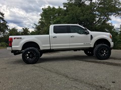 2017 Ford F-350 with a 6 inch Zone Offroad lift kit with Fox shocks and Steering Stabilizer with 22x12 Fuel Offroad Assault wheels and 37 inch Toyo Open Country MT tires with AFE 5 inch exhaust and BAK Industries MX tonneau cover