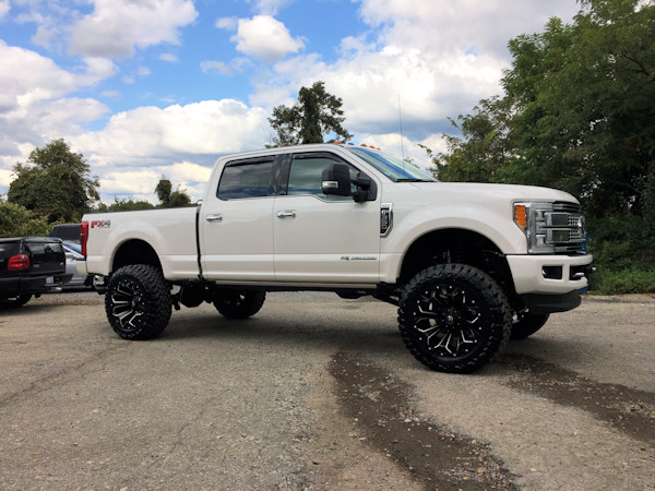 2017 Ford F-350 with a 6 inch Zone Offroad lift kit with Fox shocks and Steering Stabilizer with 22x12 Fuel Offroad Assault wheels and 37 inch Toyo Open Country MT tires with AFE 5 inch exhaust and BAK Industries MX tonneau cover 
