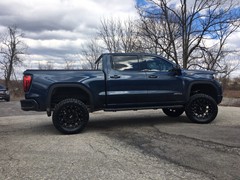 2019 GMC Sierra AT4 with 4 inch Rough Country lift kit and 20x10 KMC XD Hoss 2 wheels and 35 inch Nitto Ridge Grappler tires