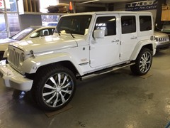 2014 Jeep Wrangler with 24 inch Helo 875 wheels, Nitto Terra Grappler tires 285/40/24.  Front and rear bumpers, mirrors, door handles, all trim and wheel inserts painted to match.  J-02241405
