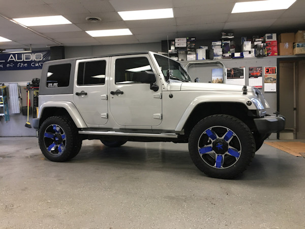 2008 Jeep Wrangler with a Terraflex leveling kit and 20 inch XD Rockstar 2 wheels with blue inserts and 33 inch Toyo Open Country AT2 tires and Magnaflow exhaust. 