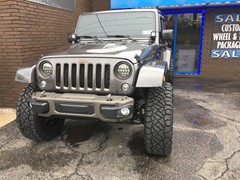 2016 Jeep Wrangler with 4 inch Zone Offroad lift kit withFox shocks and 20x10 Fuel Maverick wheels with 37 inchNitto Ridge Grappler tires and Teraflex HD spare tire mount