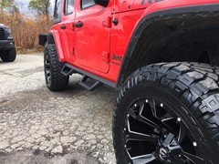 2018 Jeep Wrangler JL with 2.5 Rough Country lift kit and 20x9 Fuel Offroad Assault wheels with 35 inch Nitto Ridge Grappler tires and Rough Country nerf bars and Rough Country LED light bar and pod lights