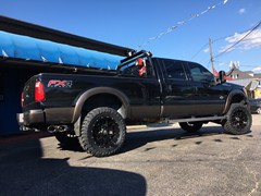 2016 Ford F-350 with 4 inch Zone Offroad lift kit with Fox shocks, 22 inch KMC XD820 Grenade wheels with 37 inch Toyo Open Country MT tires, DeeZee tool box and headache rack and Heise and Hella LED lights