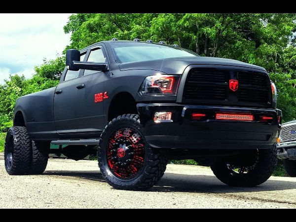 2012 Ram 3500 with full Matte Black vinyl wrap, custom red emblems, 24 inch American Force Dolla wheels (custom painted) with 37x13.50x24 Toyo Open Country MT tires.  Custom made Oracle headlights, Fog Lights, and LED light bar 
