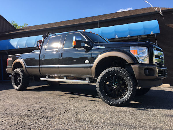 2016 Ford F-350 with 4 inch Zone Offroad lift kit with Fox shocks, 22 inch KMC XD820 Grenade wheels with 37 inch Toyo Open Country MT tires, DeeZee tool box and headache rack and Heise and Hella LED lights 