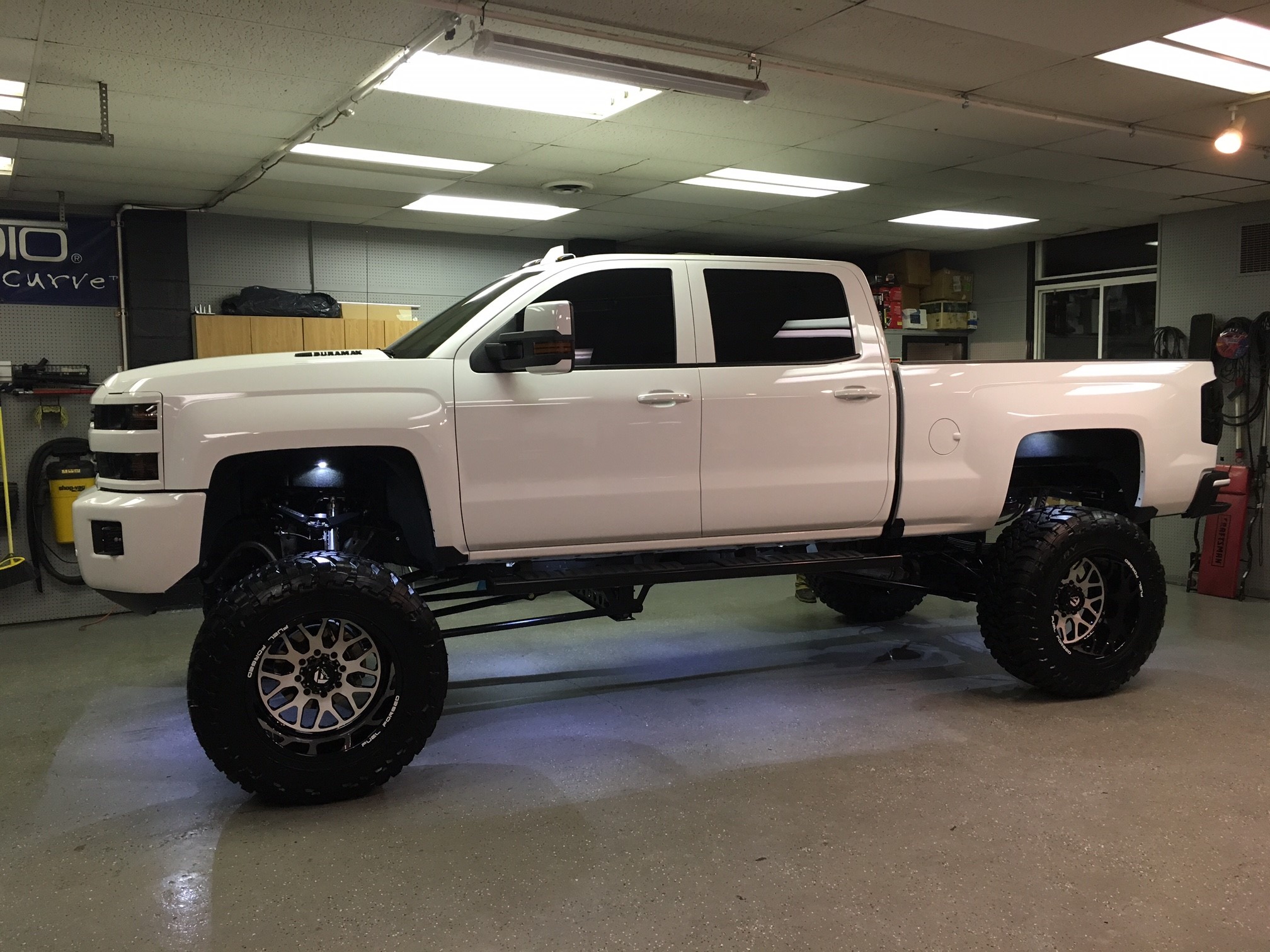 2016 Chevy Silverado 2500HD with 12 inch Cognito lift kit, 22x14 Fuel Forged FF19 wheels and 40x15.50x22 Toyo Open Country MT tires.  Rigid Industries 40 inch LED light bar custom mounted in the front bumper, Rigid Industries Dually XL fog light conver.. 