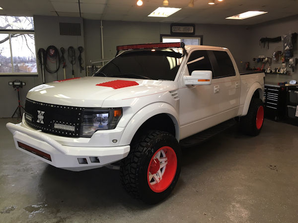 2014 Ford Raptor with 20x12 Fueloffroad 2 piece Fuel Blown wheels with custom powder coat finish and 35 inch Toyo Open Country RT tires.  54 inch Rigid Industries RDS LED light bar with red covers, Racesport Lighting RGB LED wheel lights 